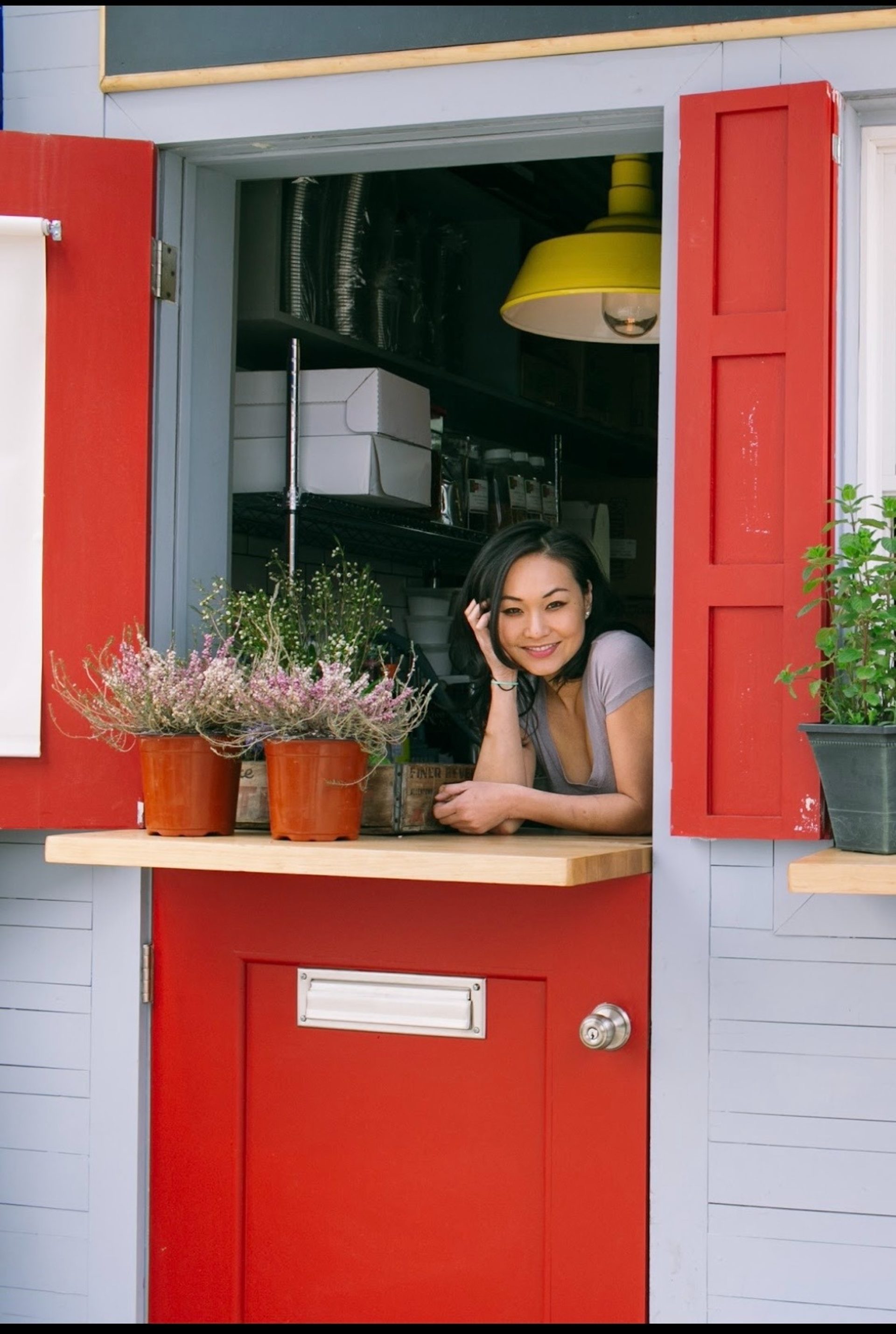 A kitchen, a window, a chef and her team